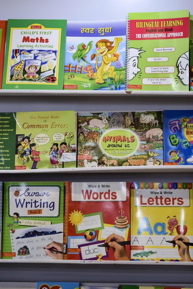 New Delhi, India, February 17 2024 - Variety of Books on shelf inside a book-stall at Delhi International Book Fair, Selection of books on display in Annual Book Fair at Bharat Mandapam complex photo