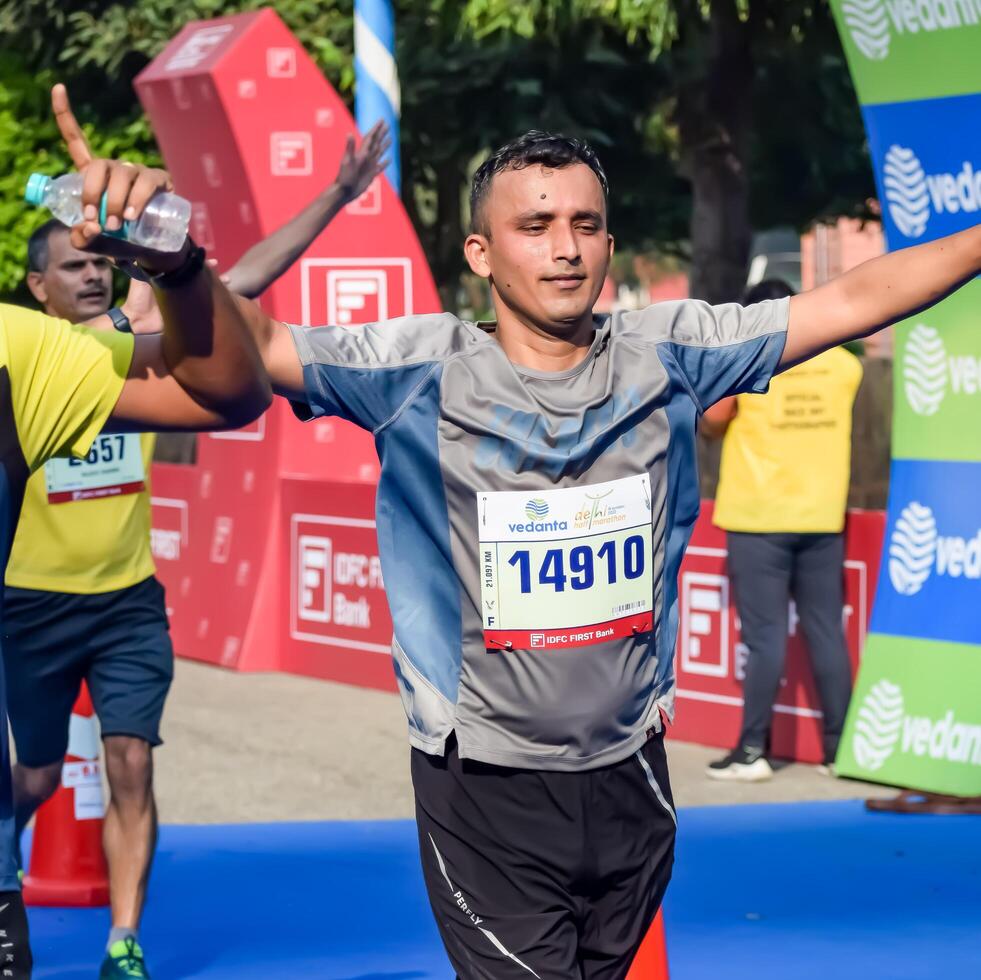 New Delhi, India - May 5 2024 - Vedanta Delhi Half Marathon race after covid in which marathon participants about to cross the finish line, Delhi Half Marathon 2023 photo