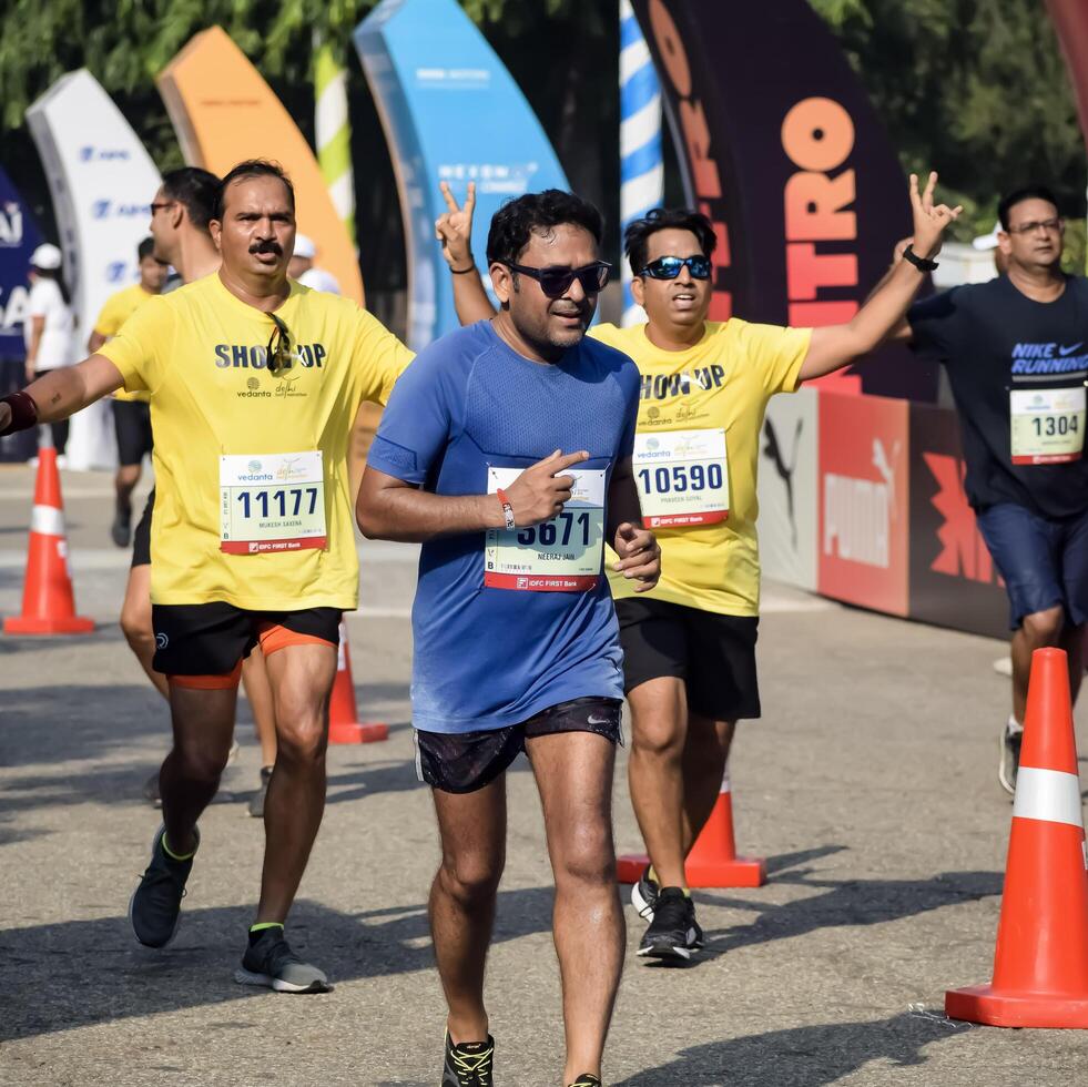 New Delhi, India - May 5 2024 - Vedanta Delhi Half Marathon race after covid in which marathon participants about to cross the finish line, Delhi Half Marathon 2023 photo