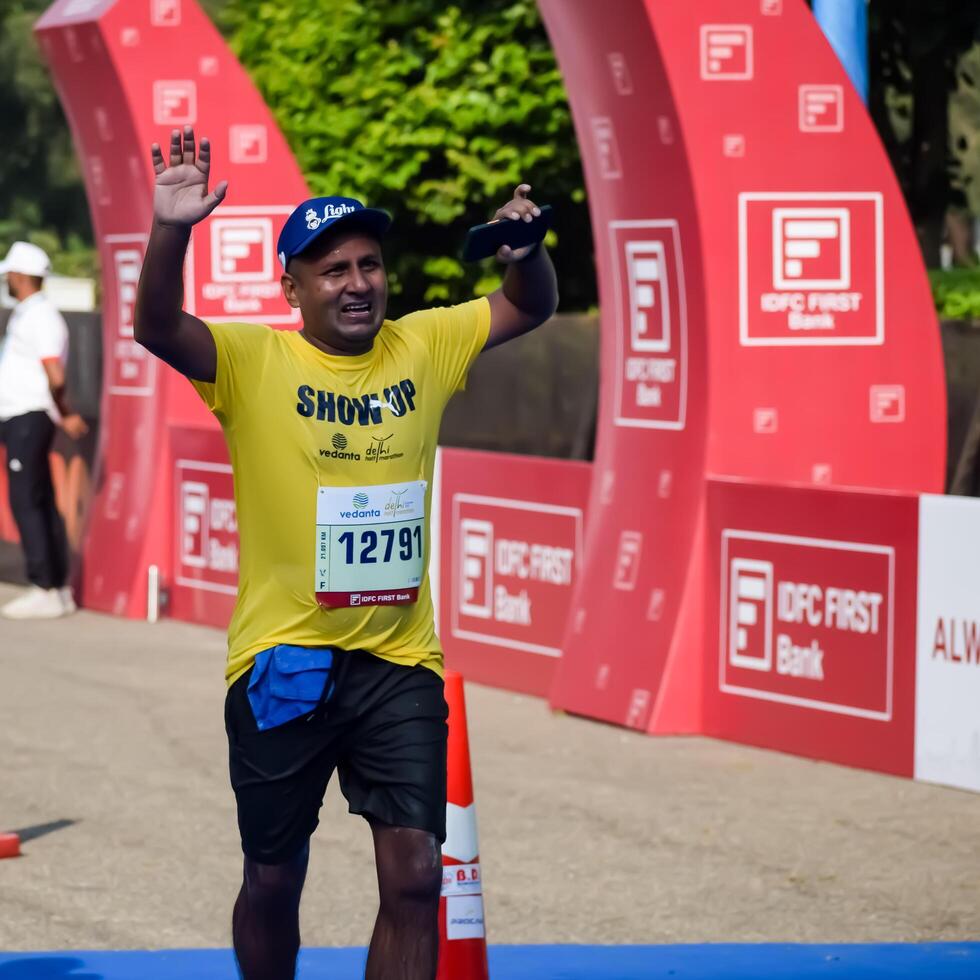 New Delhi, India - May 5 2024 - Vedanta Delhi Half Marathon race after covid in which marathon participants about to cross the finish line, Delhi Half Marathon 2023 photo