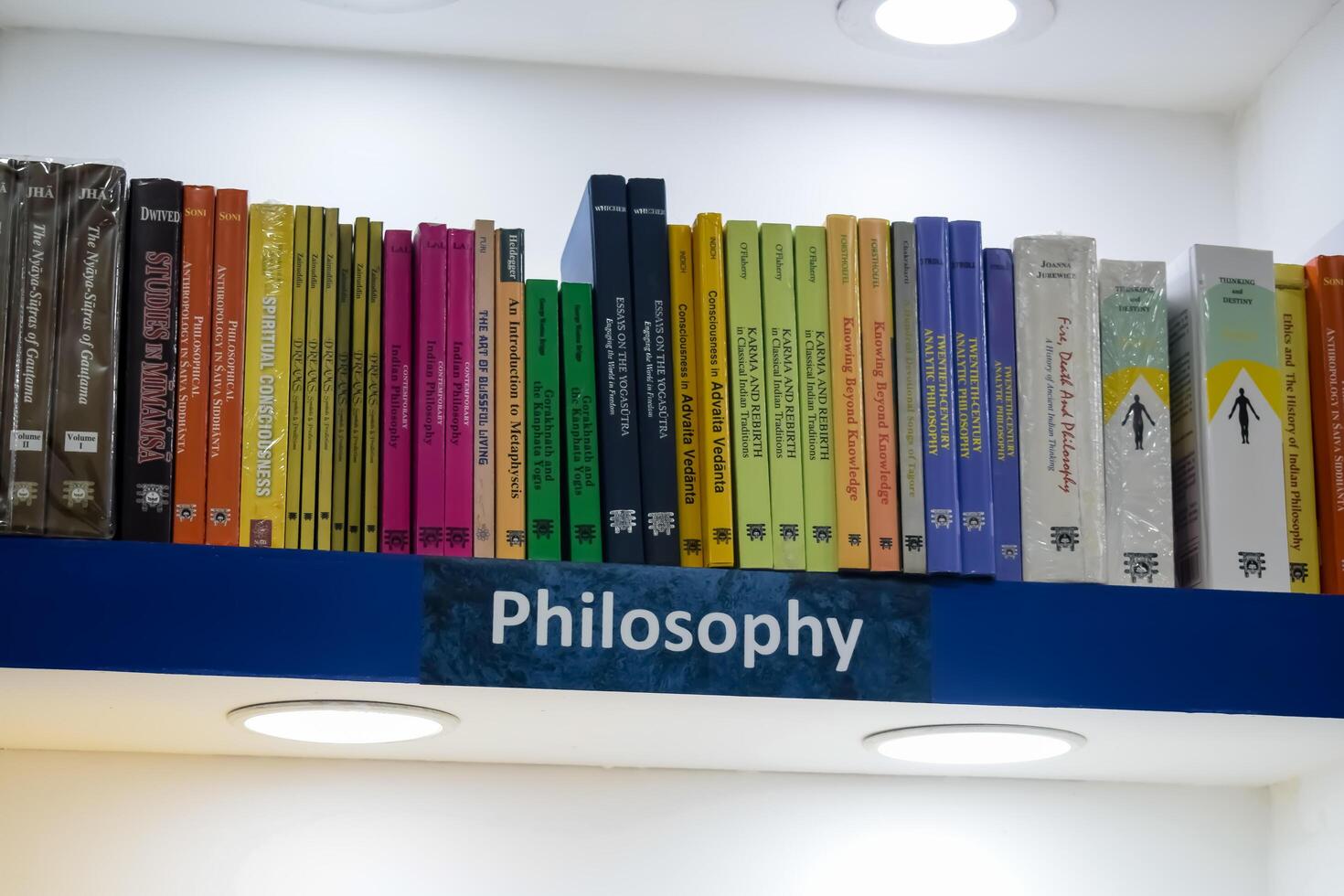 New Delhi, India, February 17 2024 - Variety of Books on shelf inside a book-stall at Delhi International Book Fair, Selection of books on display in Annual Book Fair at Bharat Mandapam complex photo