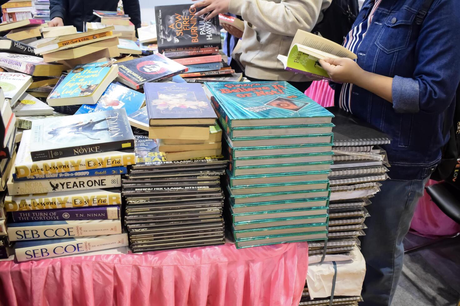 New Delhi, India, May 17 2024 - Variety of Books on shelf inside a book-stall at Delhi International Book Fair, Selection of books on display in Annual Book Fair at Bharat Mandapam complex photo