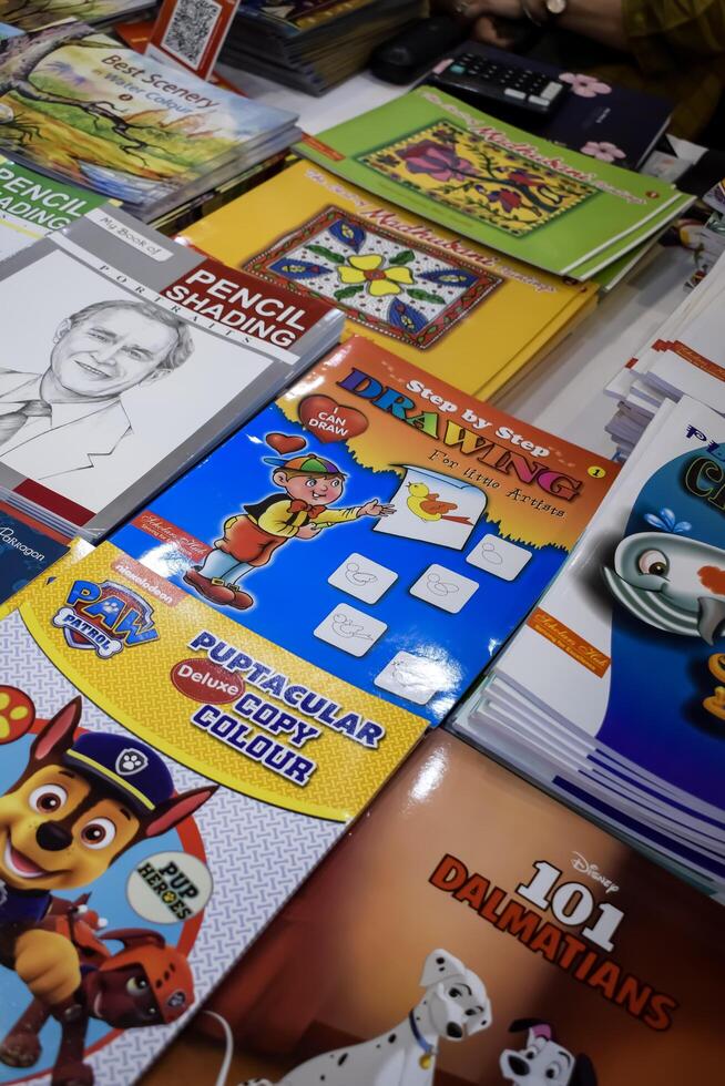 New Delhi, India, May 7 2024 - Variety of Books on shelf inside a book-stall at Delhi International Book Fair, Selection of books on display in Annual Book Fair at Bharat Mandapam complex photo