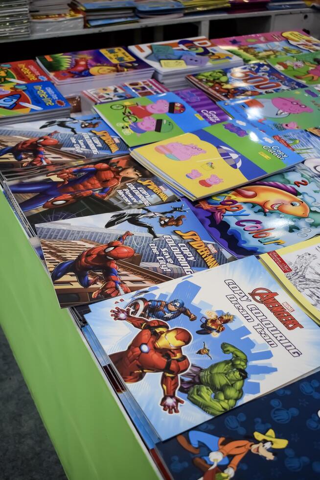 New Delhi, India, February 17 2024 - Variety of Books on shelf inside a book-stall at Delhi International Book Fair, Selection of books on display in Annual Book Fair at Bharat Mandapam complex photo