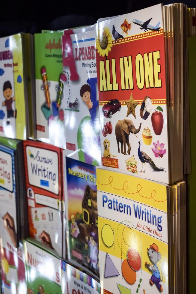 New Delhi, India, February 17 2024 - Variety of Books on shelf inside a book-stall at Delhi International Book Fair, Selection of books on display in Annual Book Fair at Bharat Mandapam complex photo