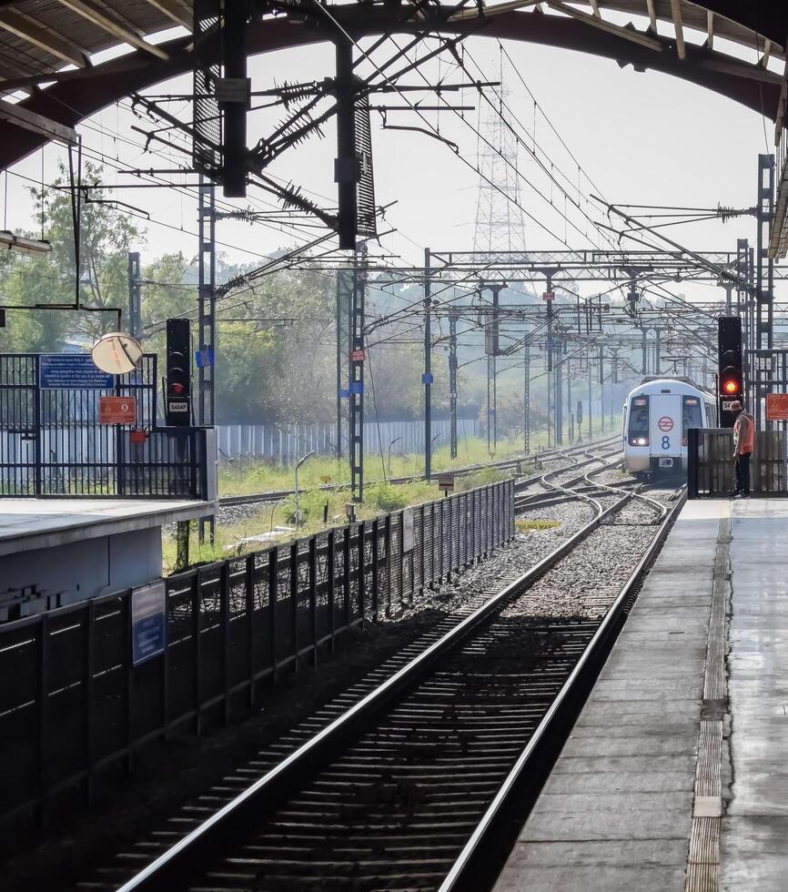 New Delhi, India, May 12 2024 - Delhi Metro train arriving at Jhandewalan metro station in New Delhi, India, Asia, Public Metro departing from Jhandewalan station photo