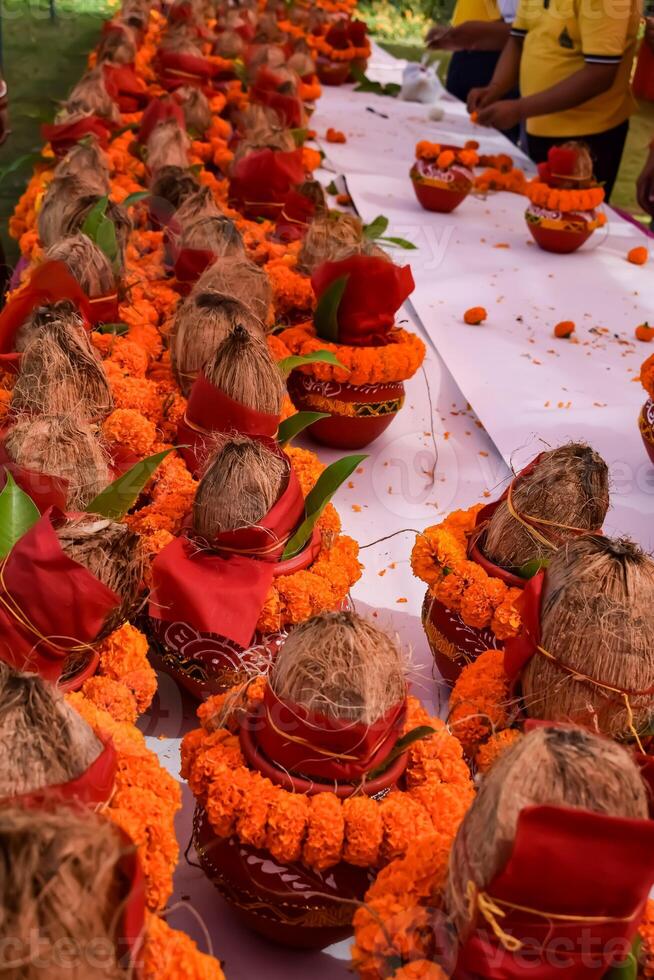 Kalash with coconut and mango leaf with floral decoration earthen pots containing sacred water. Kalash for hindu puja during Jagannath Temple Mangal Kalash Yatra, front view, closeup photo