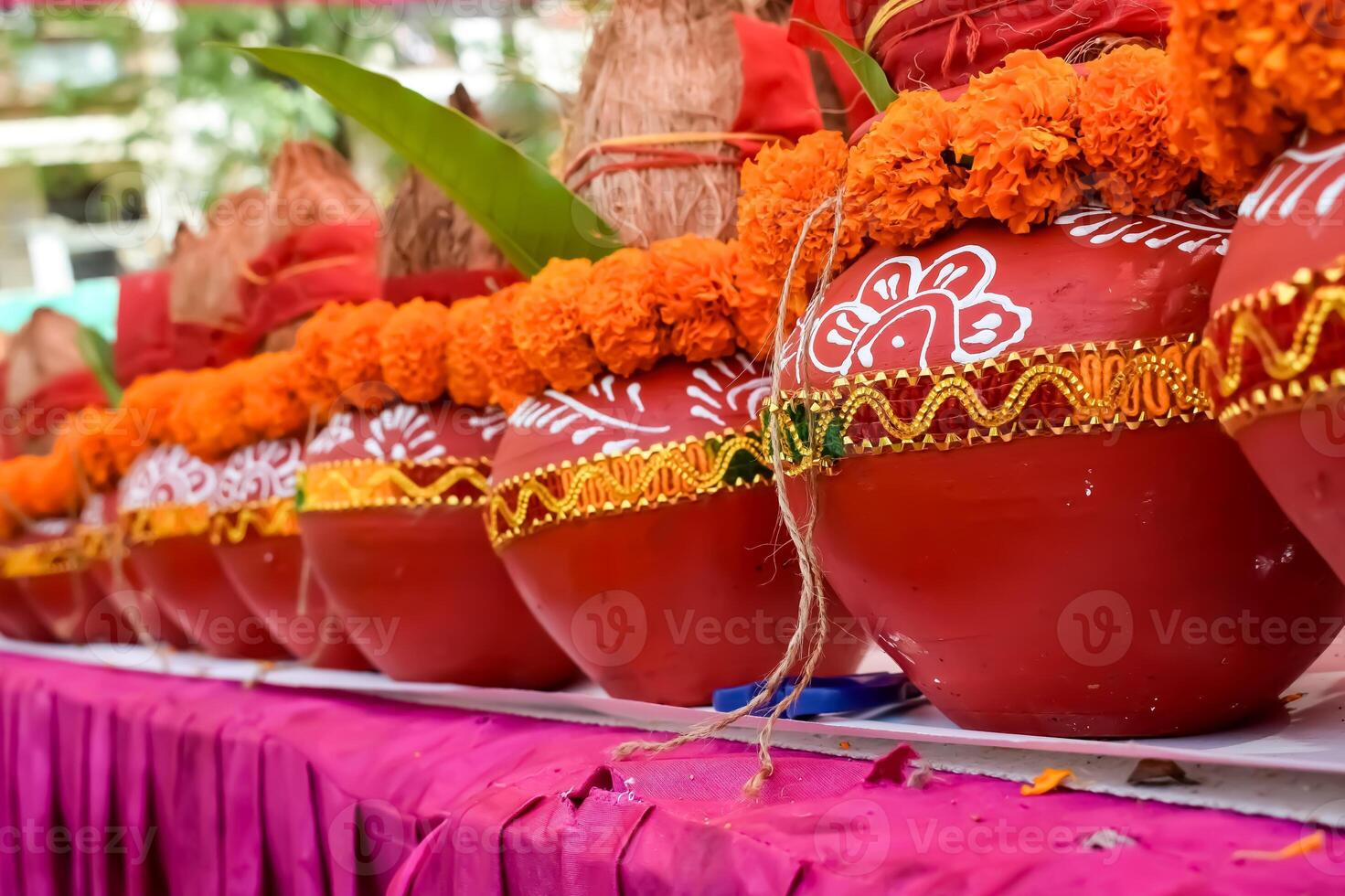 Kalash with coconut and mango leaf with floral decoration earthen pots containing sacred water. Kalash for hindu puja during Jagannath Temple Mangal Kalash Yatra, front view, closeup photo