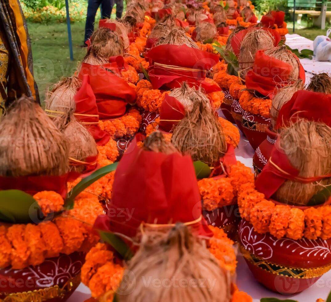 Kalash with coconut and mango leaf with floral decoration earthen pots containing sacred water. Kalash for hindu puja during Jagannath Temple Mangal Kalash Yatra, front view, closeup photo