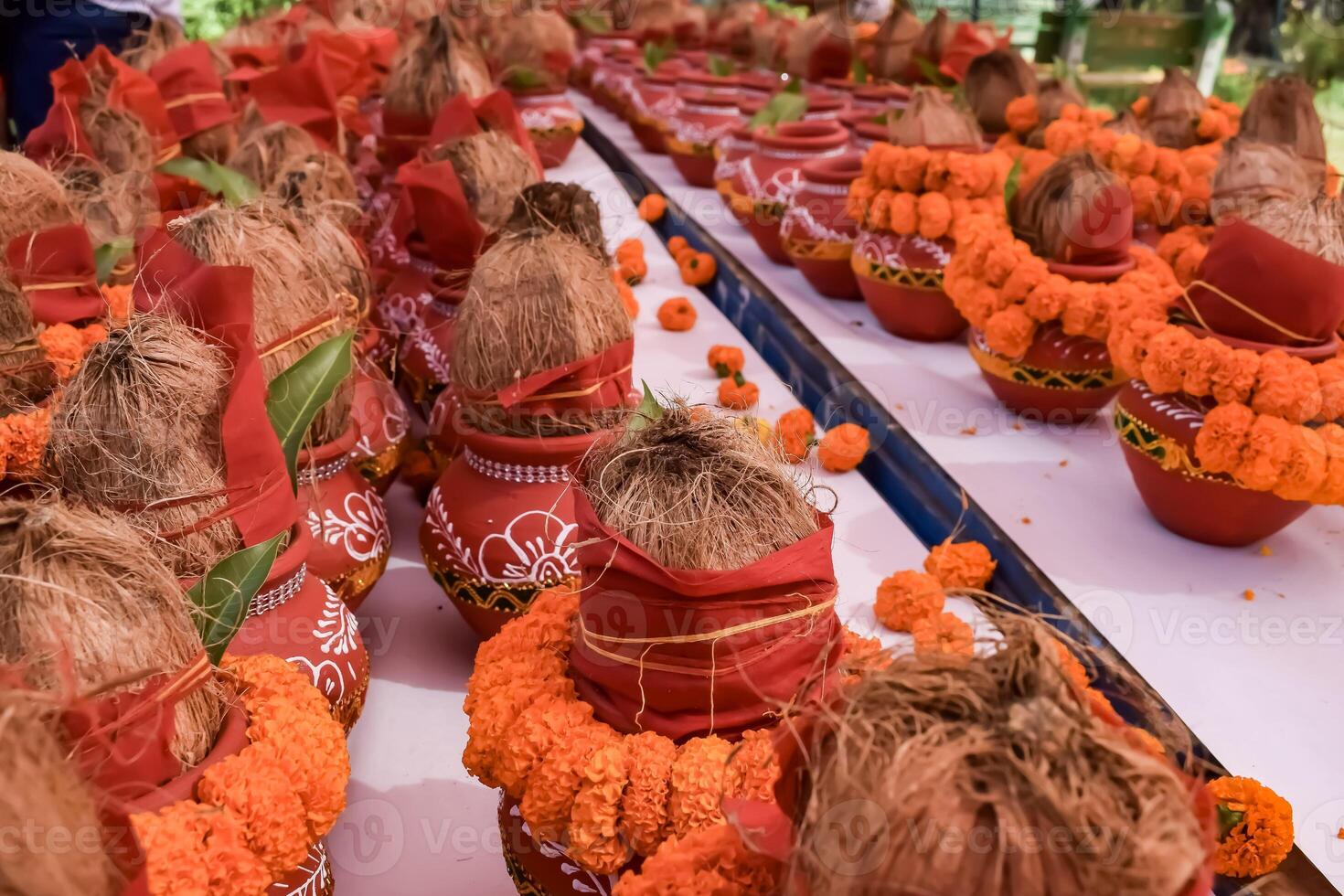 Kalash with coconut and mango leaf with floral decoration earthen pots containing sacred water. Kalash for hindu puja during Jagannath Temple Mangal Kalash Yatra, front view, closeup photo
