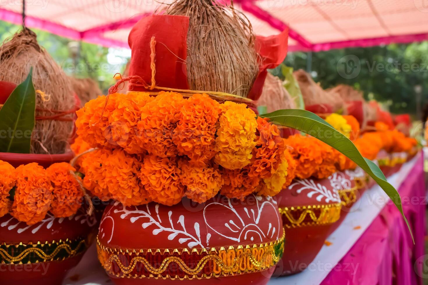 Kalash with coconut and mango leaf with floral decoration earthen pots containing sacred water. Kalash for hindu puja during Jagannath Temple Mangal Kalash Yatra, front view, closeup photo