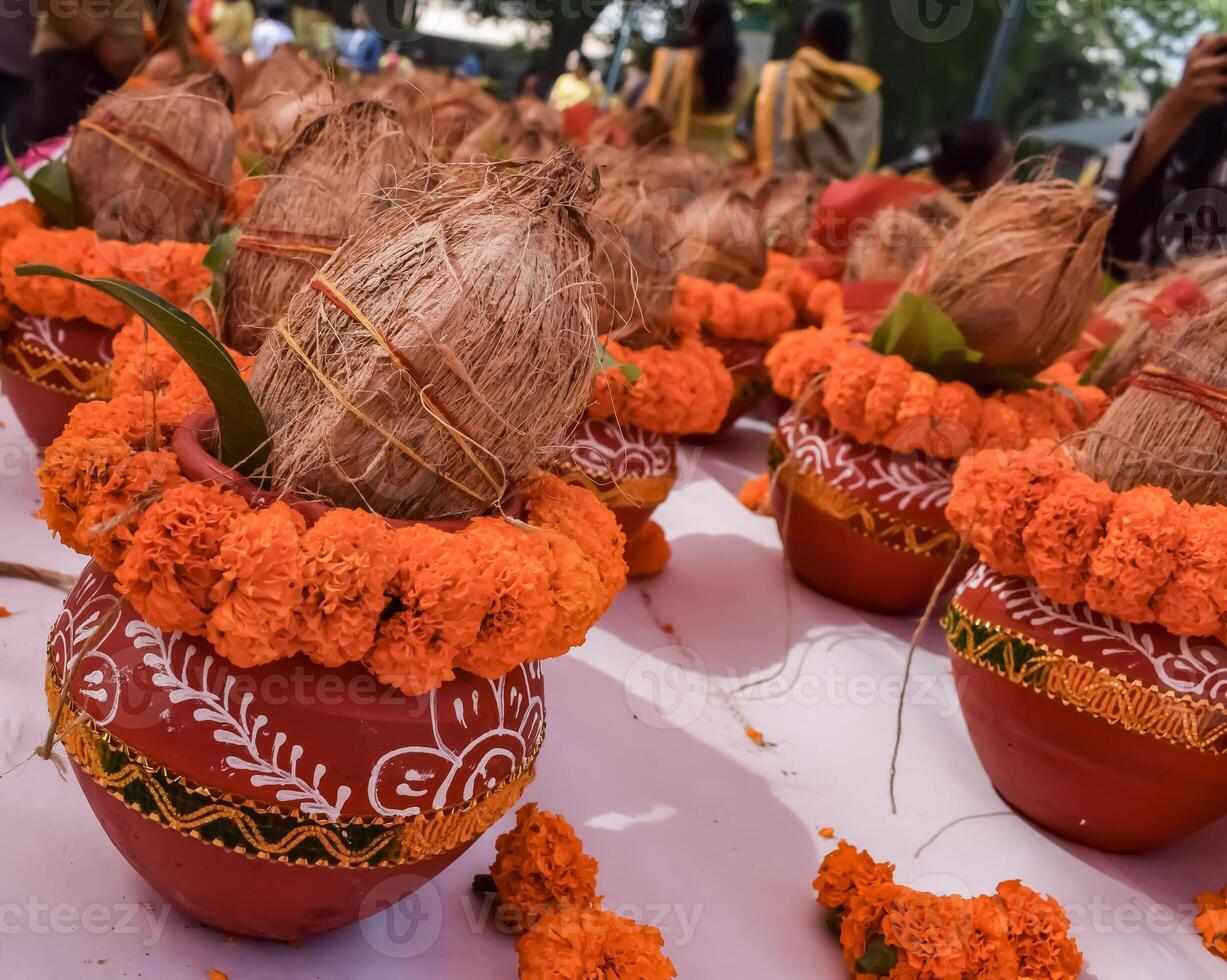 Kalash with coconut and mango leaf with floral decoration earthen pots containing sacred water. Kalash for hindu puja during Jagannath Temple Mangal Kalash Yatra, front view, closeup photo
