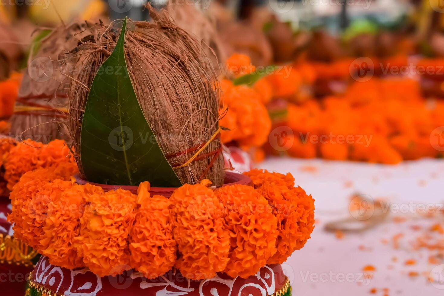 Kalash with coconut and mango leaf with floral decoration earthen pots containing sacred water. Kalash for hindu puja during Jagannath Temple Mangal Kalash Yatra, front view, closeup photo