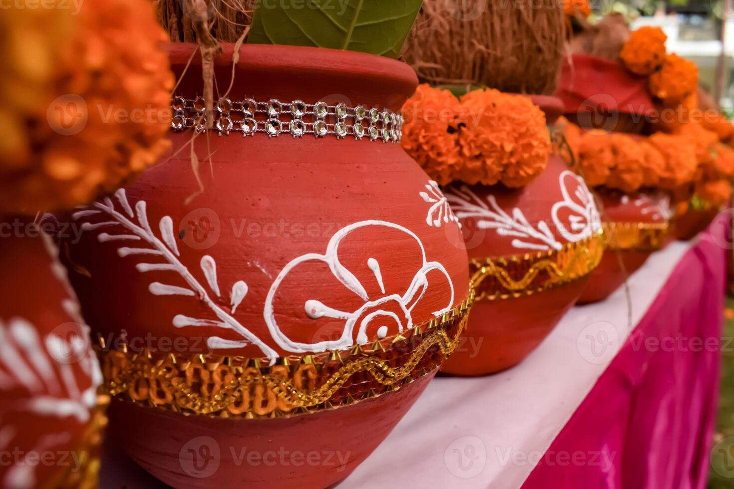 Kalash with coconut and mango leaf with floral decoration earthen pots containing sacred water. Kalash for hindu puja during Jagannath Temple Mangal Kalash Yatra, front view, closeup photo