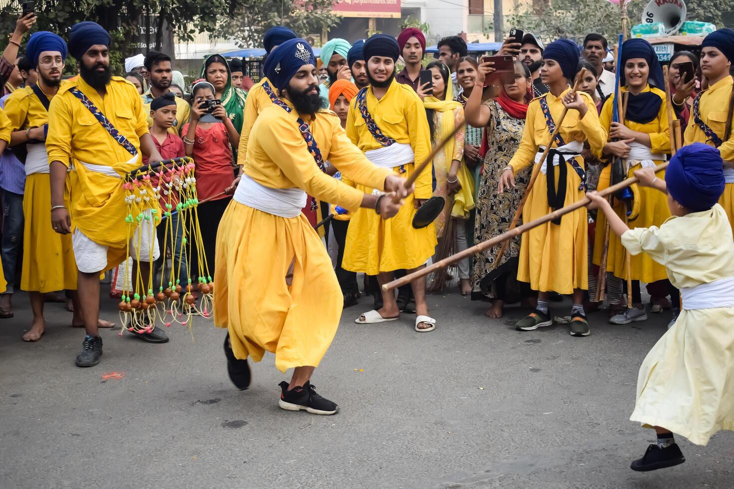 Delhi, India, May 2, 2024 - Sikhs display gatka and martial arts during annual Nagar Kirtan, Traditional, procession on account of birthday of Guru Nanak Dev ji, Nagar Kirtan in East Delhi area photo