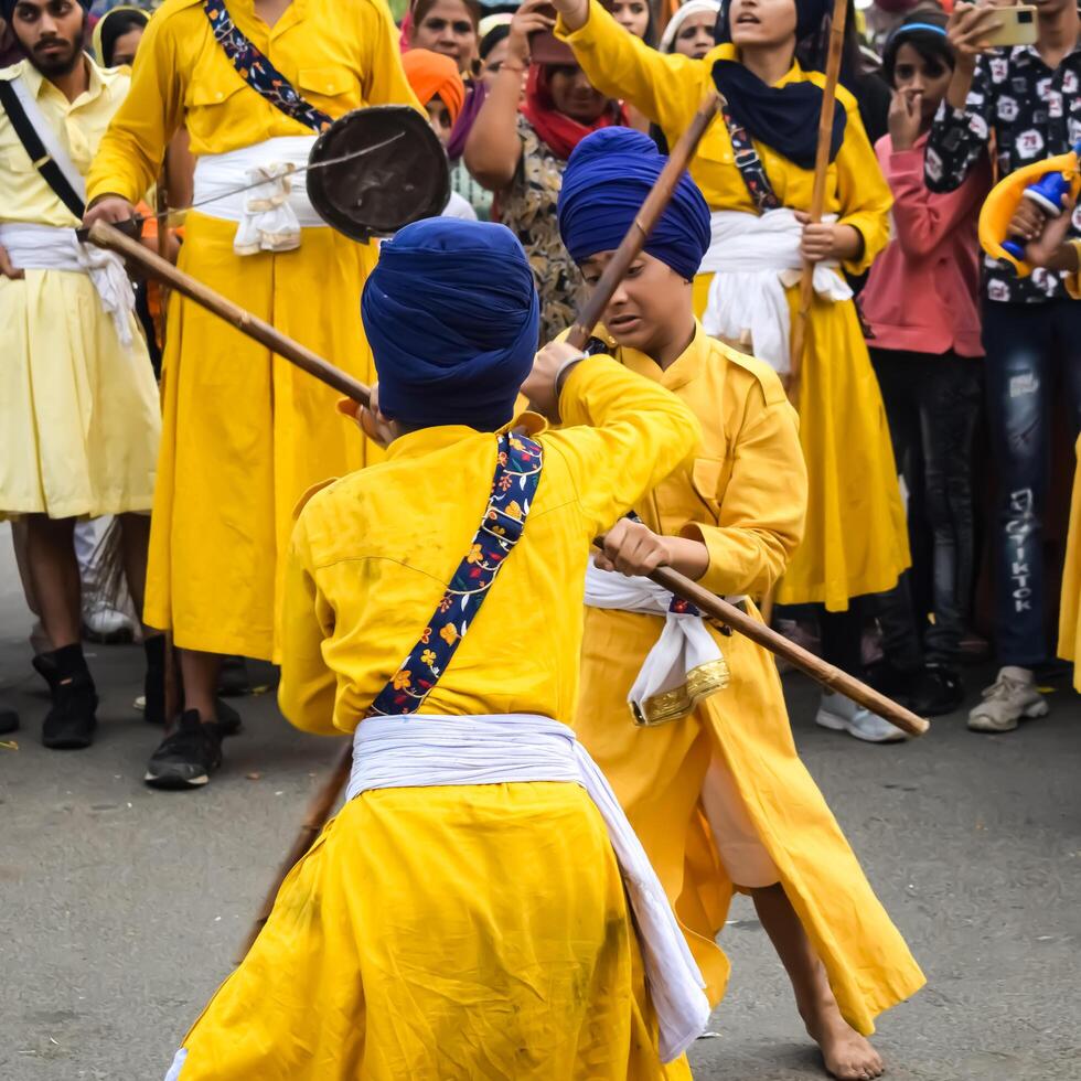 Delhi, India, May 2, 2024 - Sikhs display gatka and martial arts during annual Nagar Kirtan, Traditional, procession on account of birthday of Guru Nanak Dev ji, Nagar Kirtan in East Delhi area photo