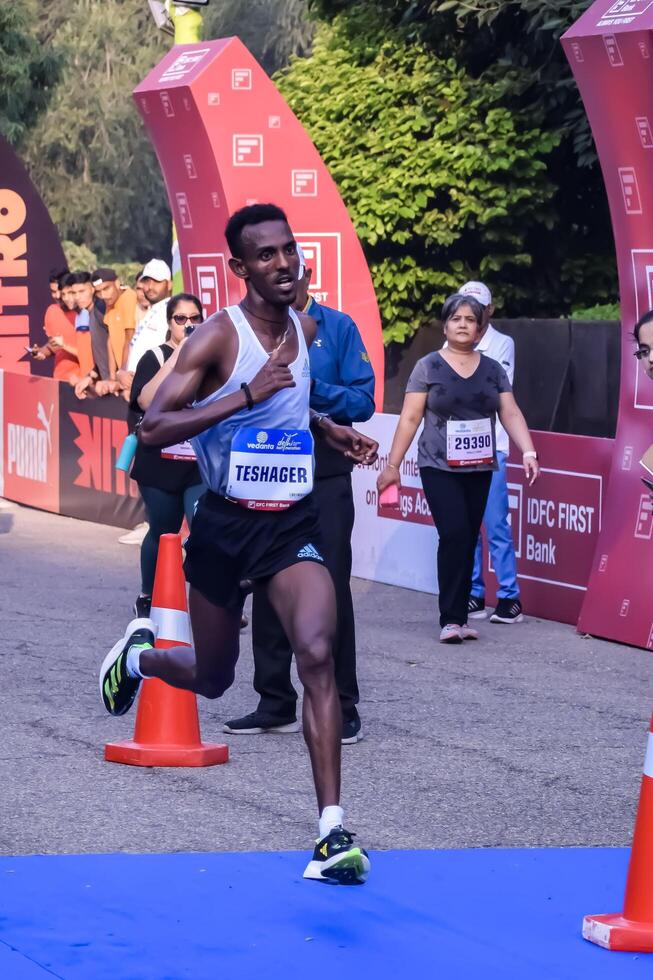 New Delhi, India - May 5 2024 - Vedanta Delhi Half Marathon race after covid in which marathon participants about to cross the finish line, Delhi Half Marathon 2023 photo