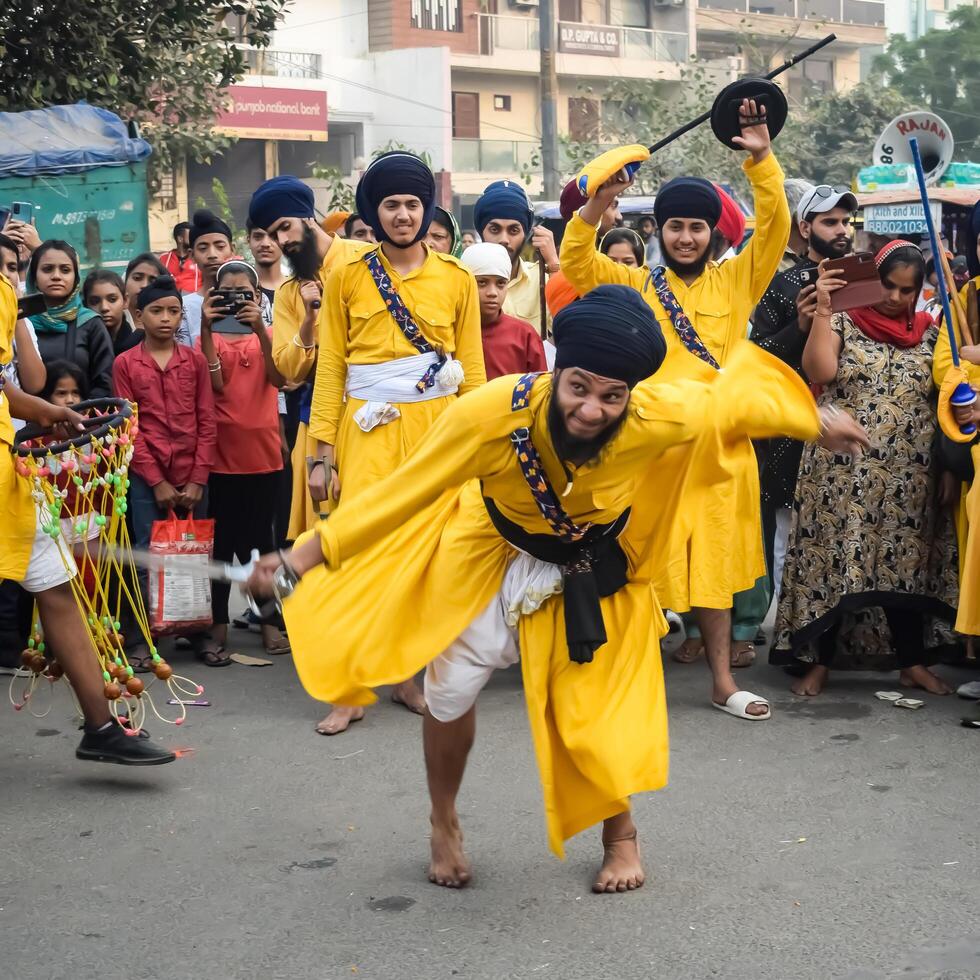 Delhi, India, May 2, 2024 - Sikhs display gatka and martial arts during annual Nagar Kirtan, Traditional, procession on account of birthday of Guru Nanak Dev ji, Nagar Kirtan in East Delhi area photo