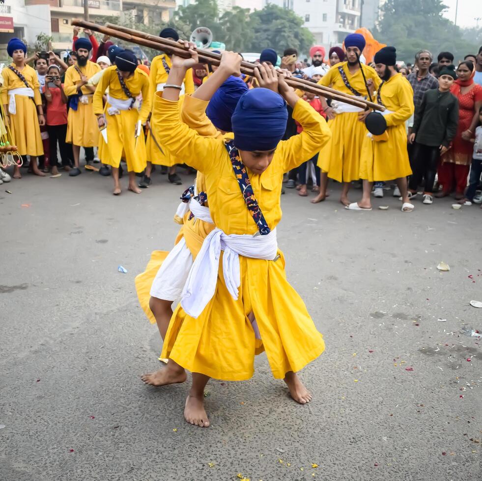 Delhi, India, May 2, 2024 - Sikhs display gatka and martial arts during annual Nagar Kirtan, Traditional, procession on account of birthday of Guru Nanak Dev ji, Nagar Kirtan in East Delhi area photo