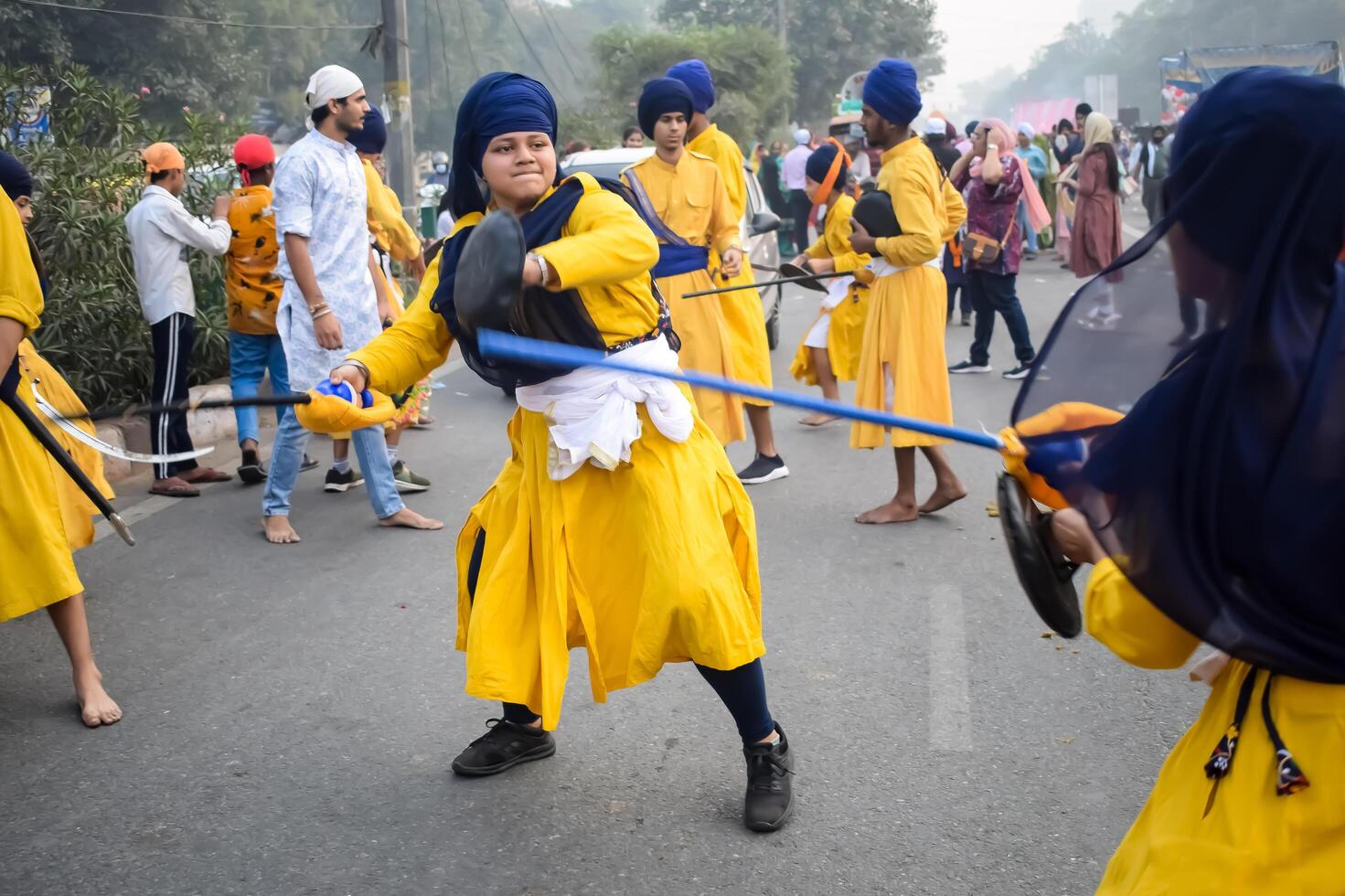 Delhi, India, May 2, 2024 - Sikhs display gatka and martial arts during annual Nagar Kirtan, Traditional, procession on account of birthday of Guru Nanak Dev ji, Nagar Kirtan in East Delhi area photo