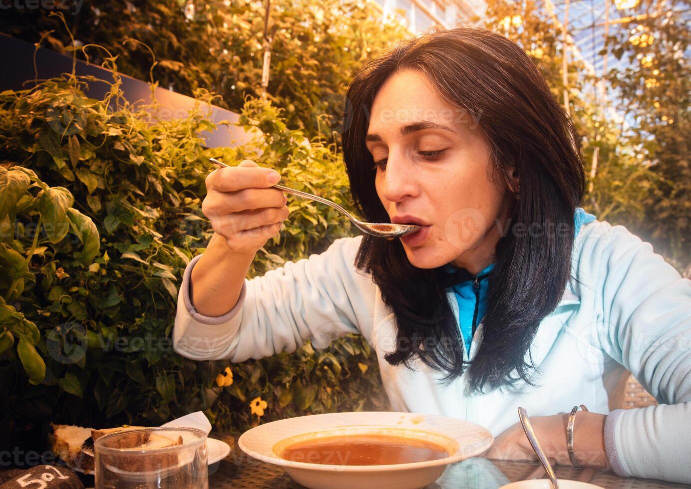 South Iceland, 2023 - caucasian tourist woman visitor eat portion of mussels in Fridheimar - visitors friendly tomato farm and restaurant in Iceland photo