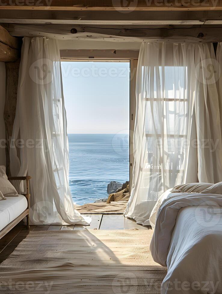 A bedroom with a large window overlooking the ocean photo