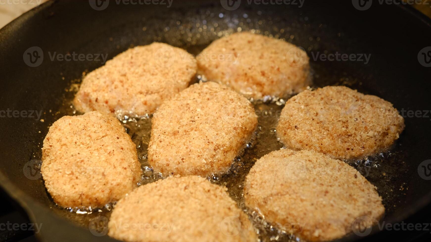 Fried cutlets in a frying pan with sunflower oil. Rustic menu. Traditional rustic food. Close-up. Homemade hamburger cutlets photo