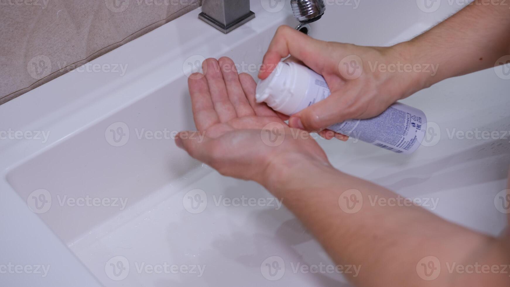 A man uses shaving foam press it on the palm photo