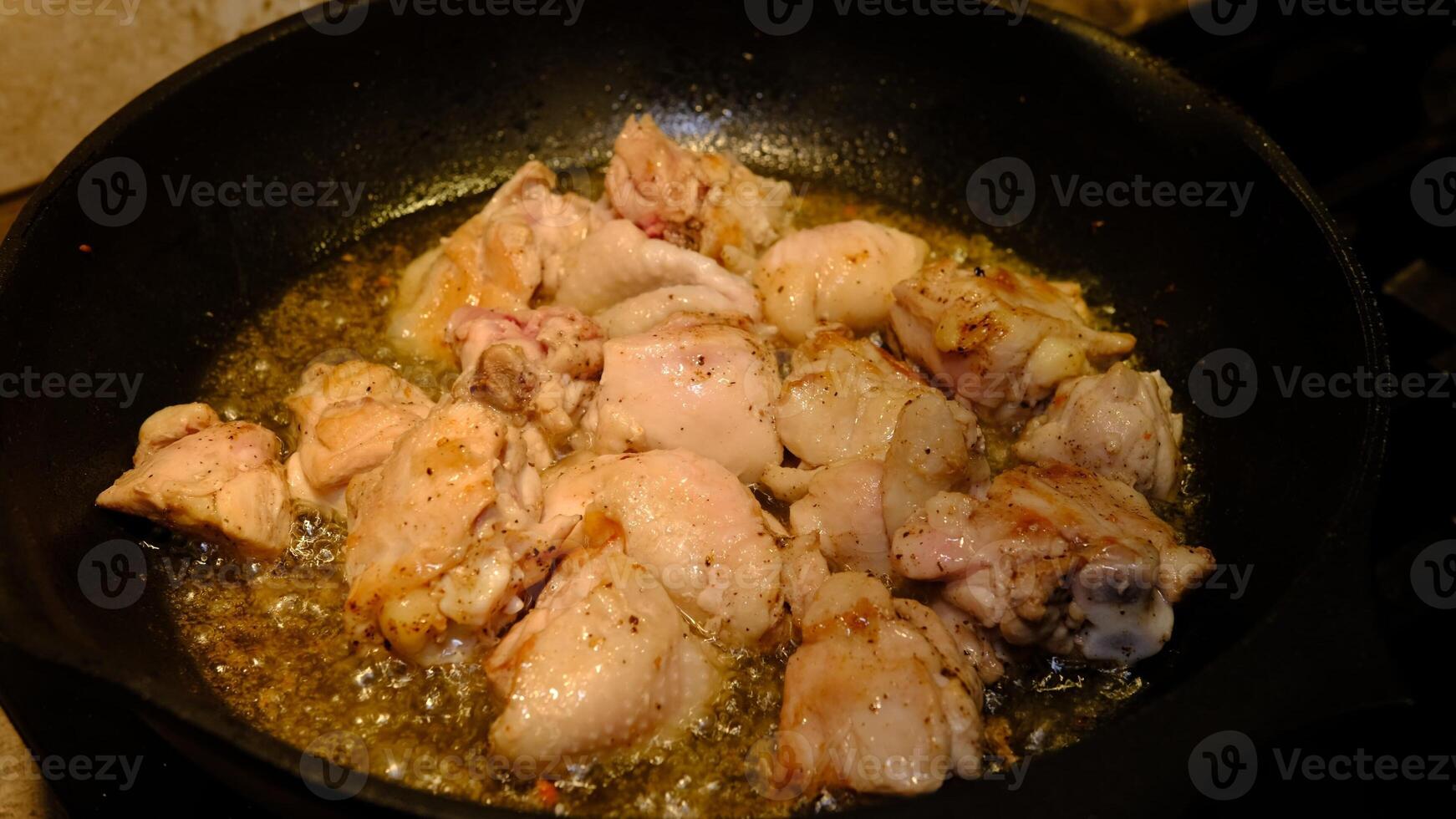 Delicious chicken in frying pan, in sunflower oil photo