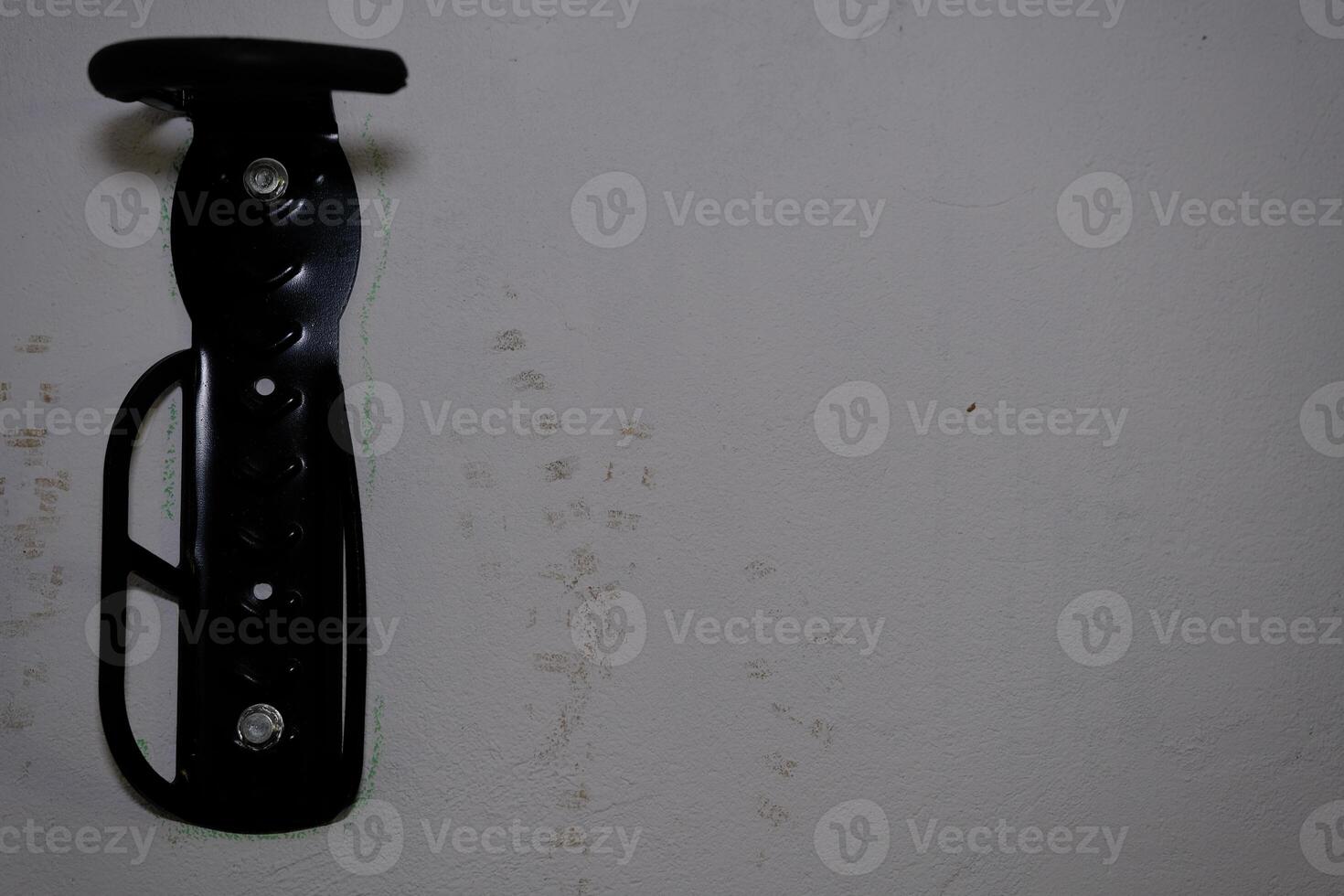 Bicycle tire hook clamp on the wall photo