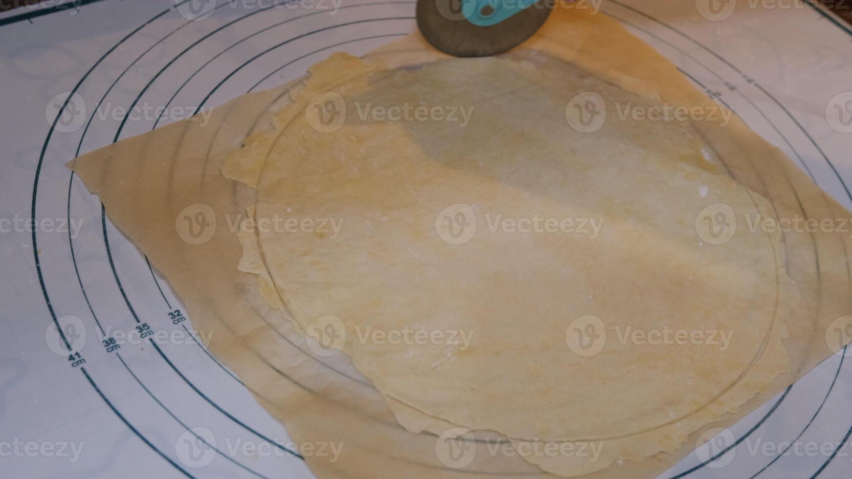 Cutting cookies with a cookie cutter on the size meter board photo