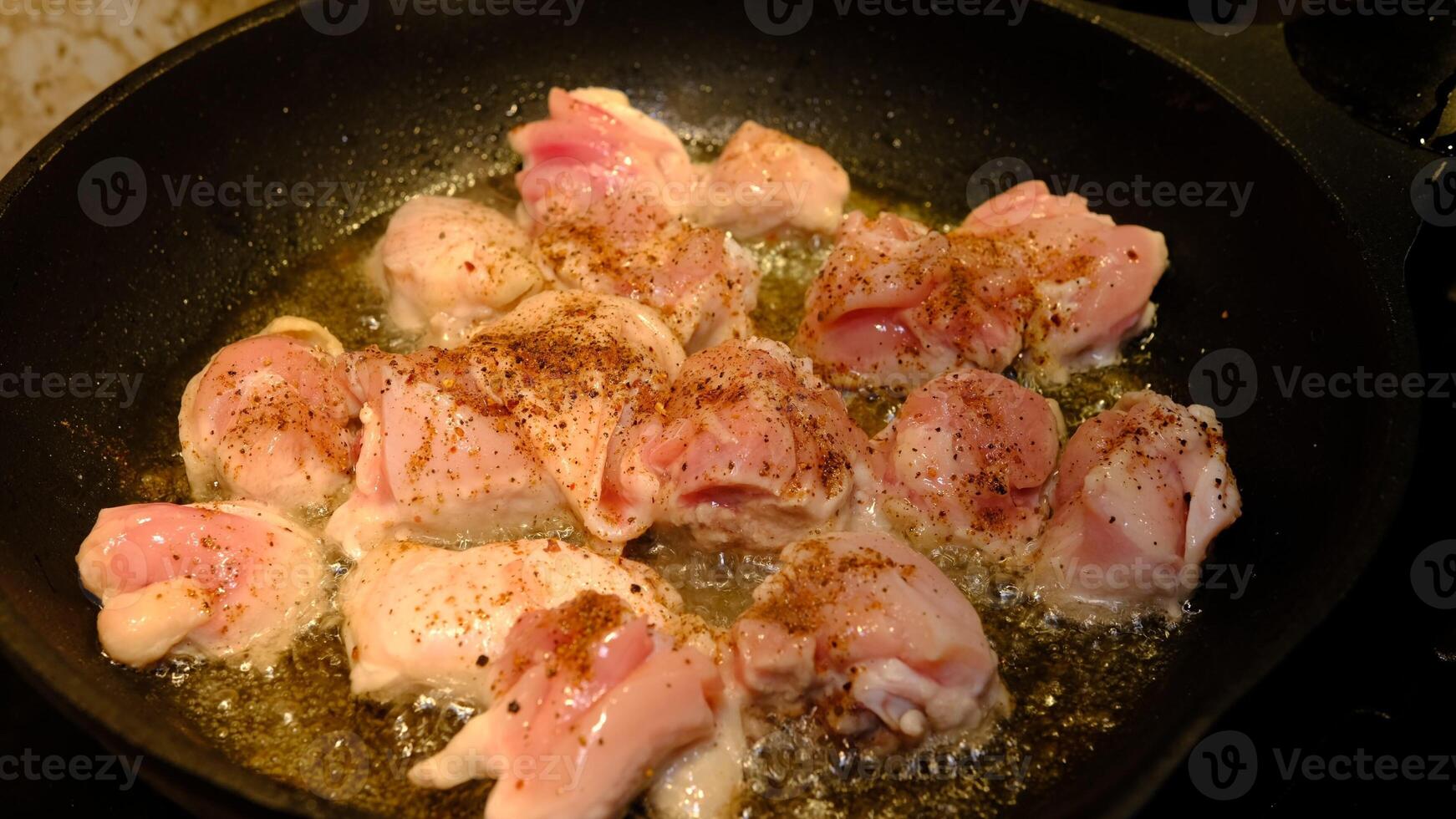 Delicious chicken in frying pan, in sunflower oil photo