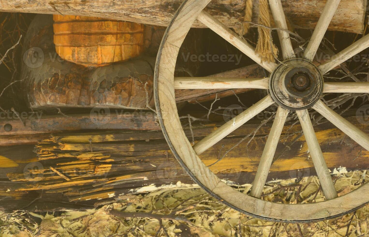The old wooden wheel from the carriage hangs on the wall of the Ukrainian barn photo