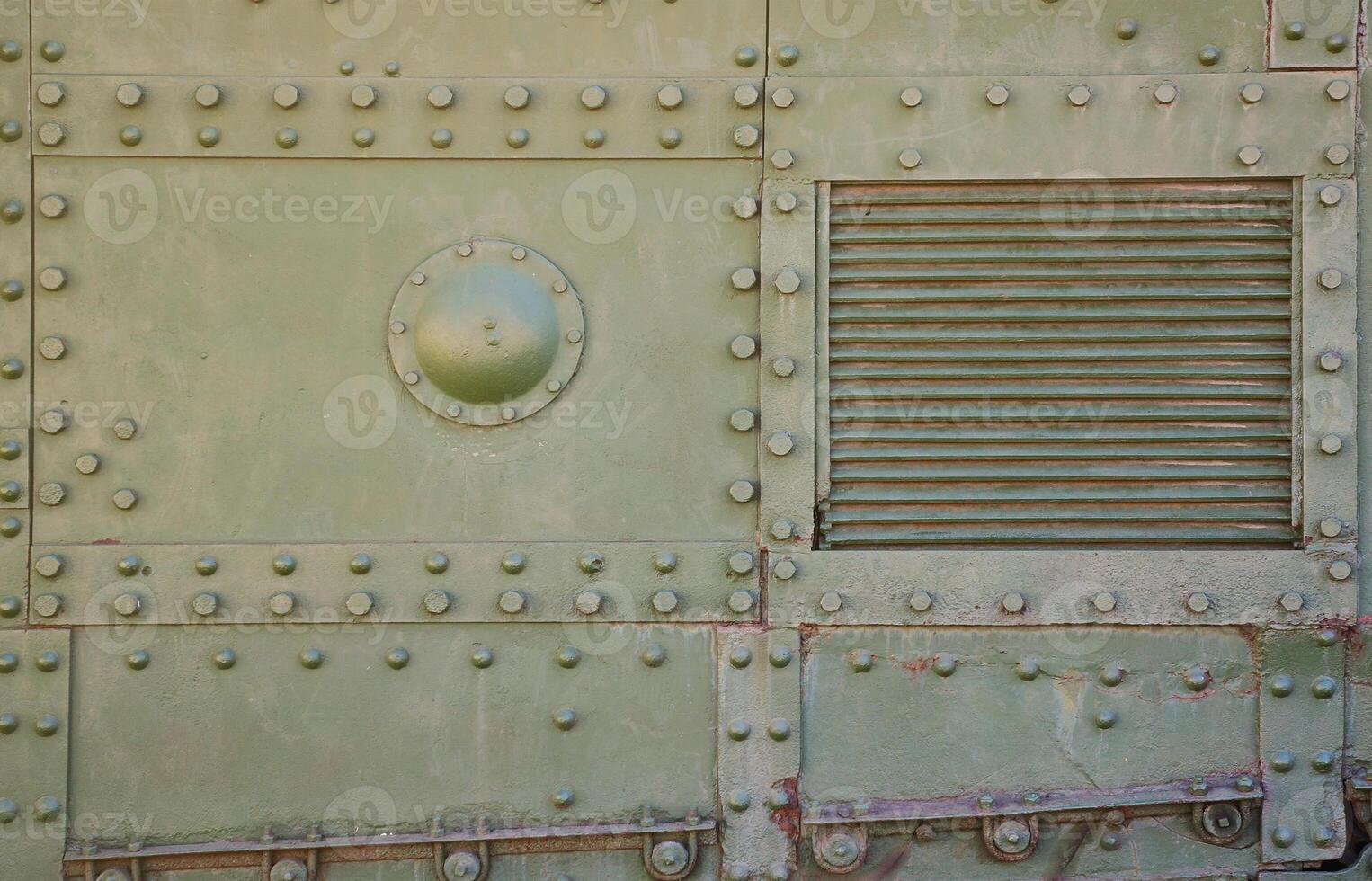 The texture of the wall of the tank, made of metal and reinforced with a multitude of bolts and rivets. Images of the covering of a combat vehicle from the Second World War photo