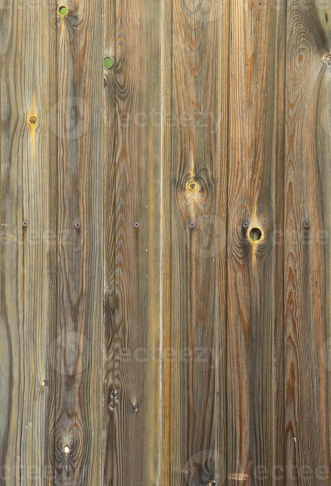 Old grunge dark brown wood panel pattern with beautiful abstract grain surface texture, vertical striped background or backdrop in architectural material decoration concepts, vintage or retro style photo