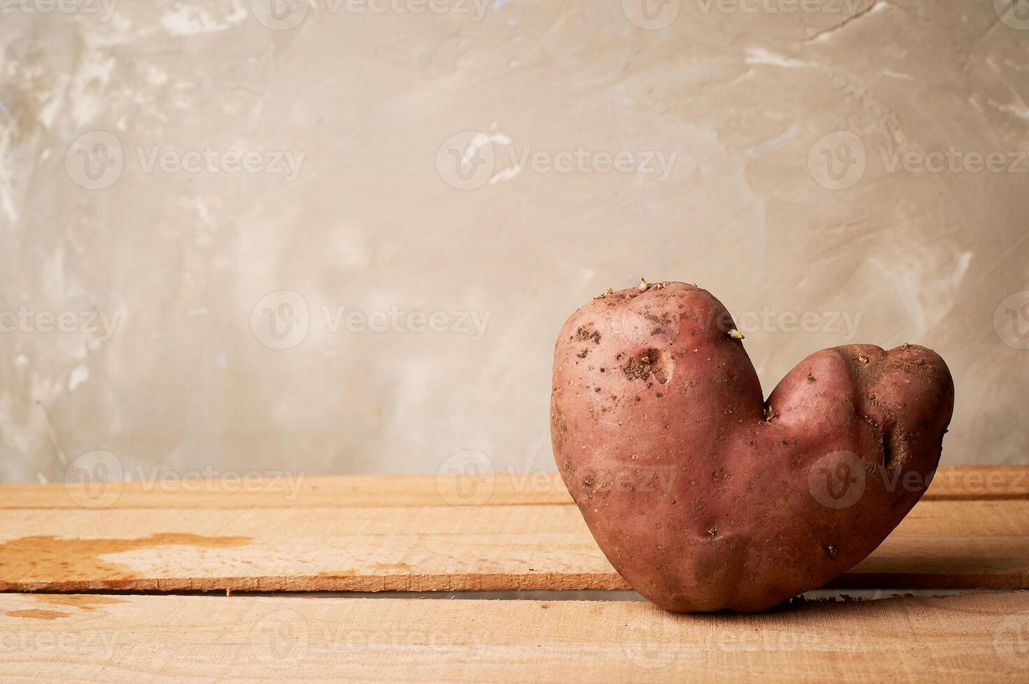 Ugly food, potatoes in the shape of a heart.Natural and simple farm products. photo