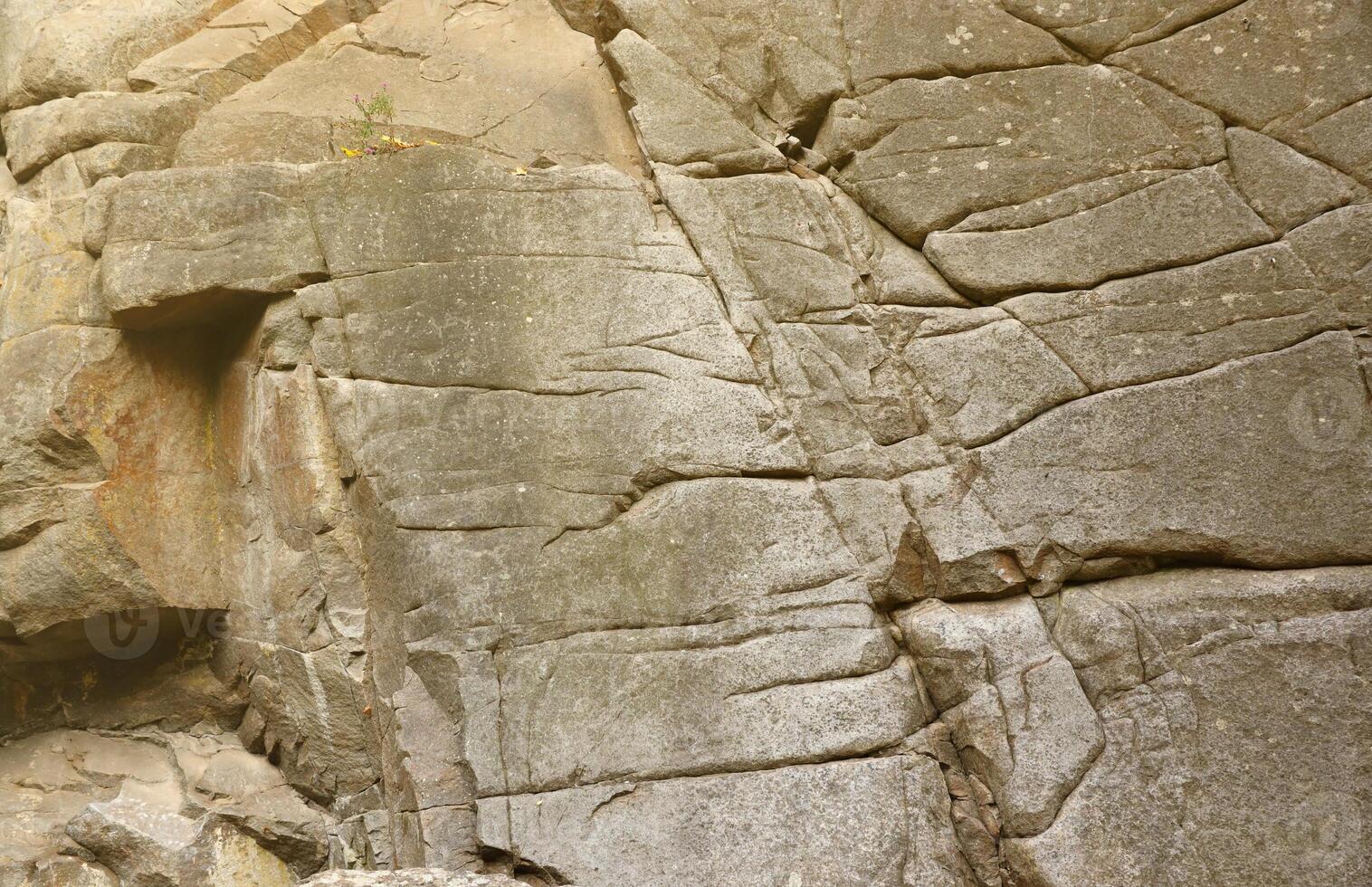 Light coarse natural rock stone background. Mining cliff rough front surface. Big limestone stack backdrop. Heavy grunge damaged granite block texture photo