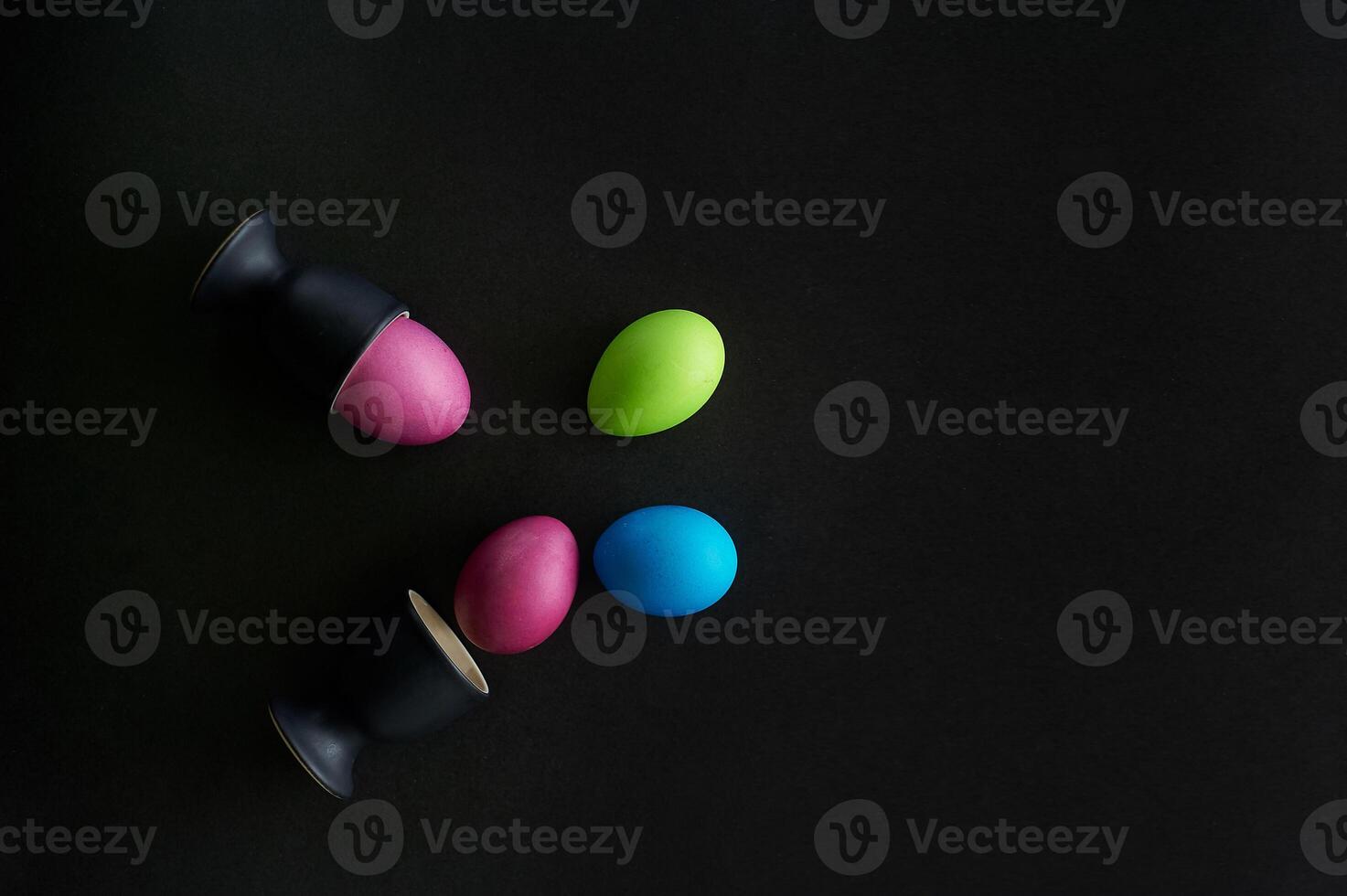 Painted eggs on a black background.Dietary protein diet. Minimalism. photo