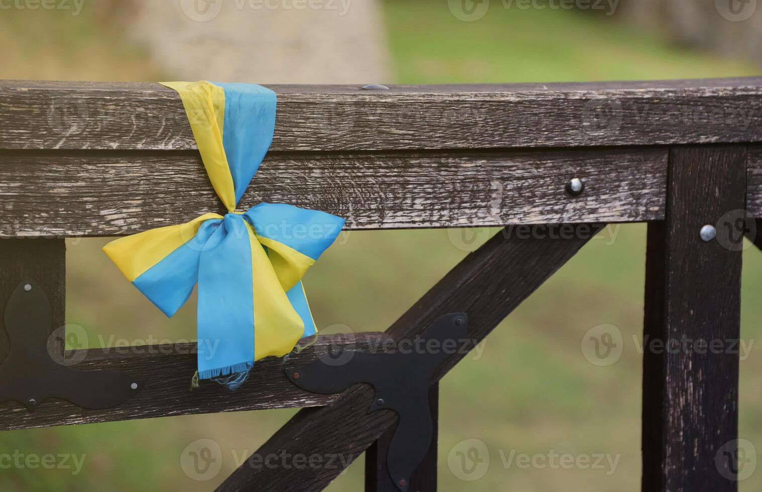 Ribbons in the colors of the national flag of Ukraine are tied to the handrail photo