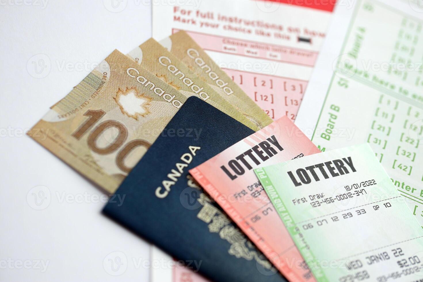 Lottery tickets lies with canadian dollars on gambling sheets with numbers for marking to play lottery photo