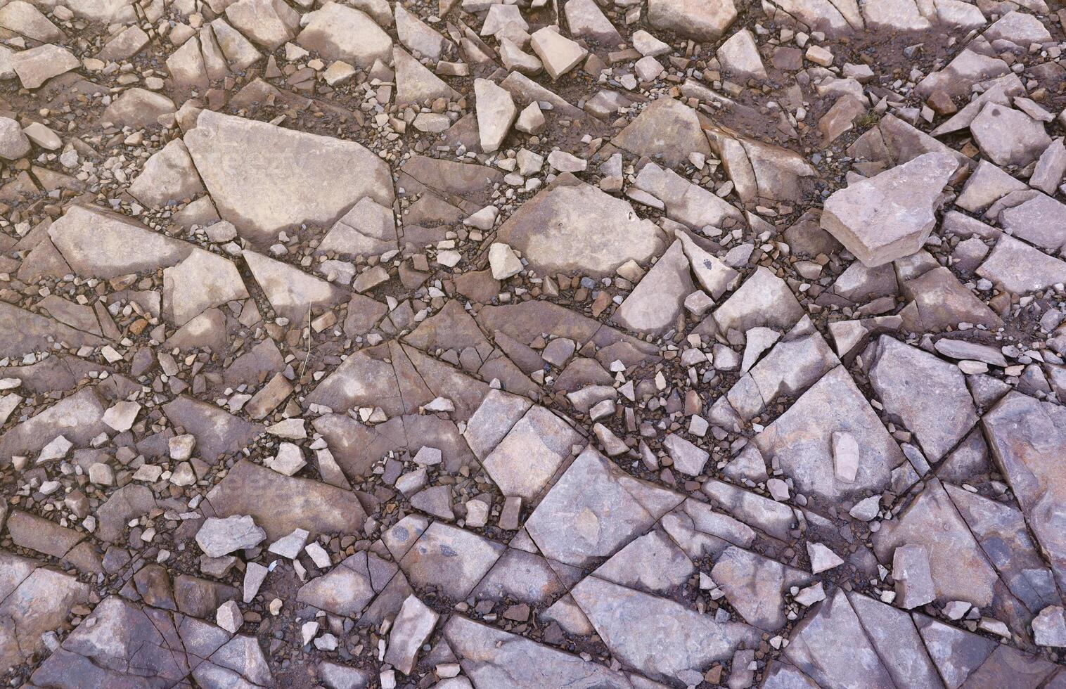 Background of shattered stony stones surface in mountain area. Texture with natural light photo