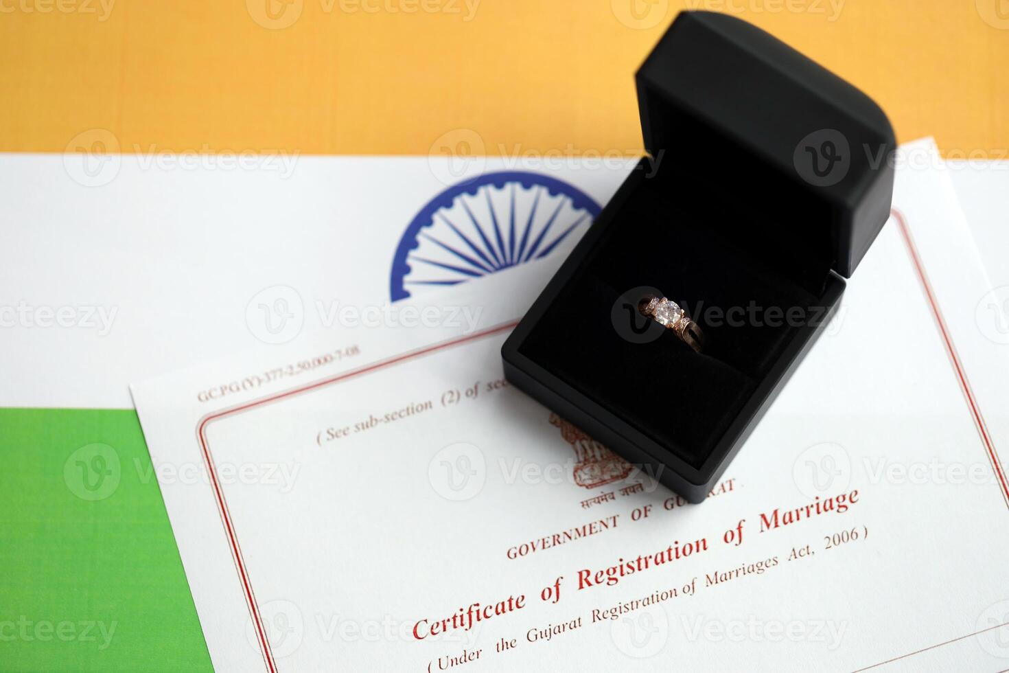 Indian Certificate of registration of marriage blank document and wedding ring on flag photo