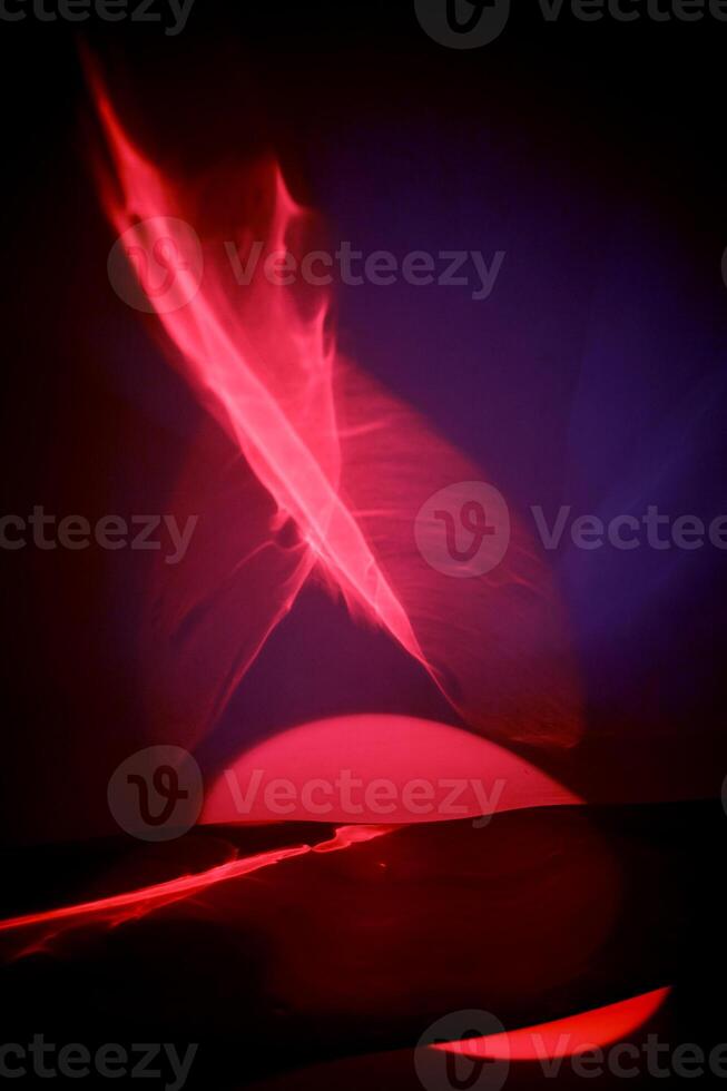 Reflection of red light in a liquid mirror, abstraction. Red fire, fire and love passion. photo