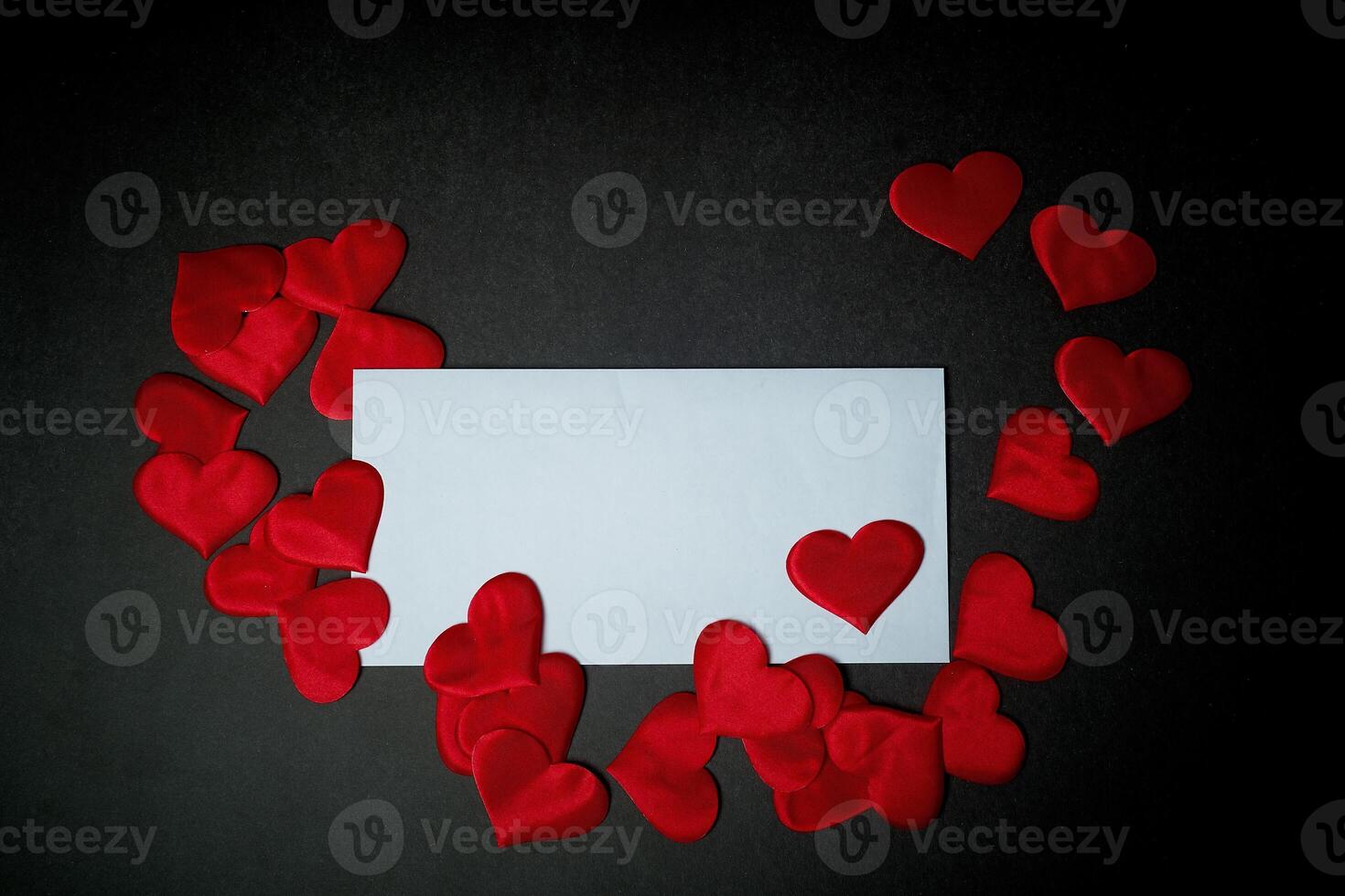 Valentine's day,a Declaration of love.White envelope with red hearts. Valentine. On a dark gray background. photo