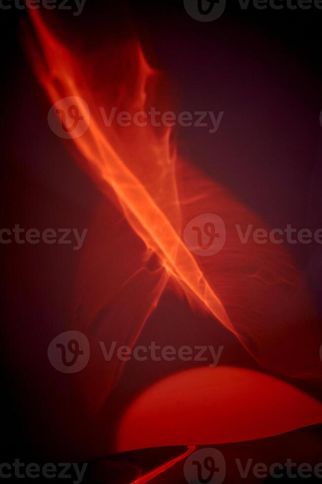 Reflection of red light in a liquid mirror, abstraction. Red fire, fire and love passion. photo