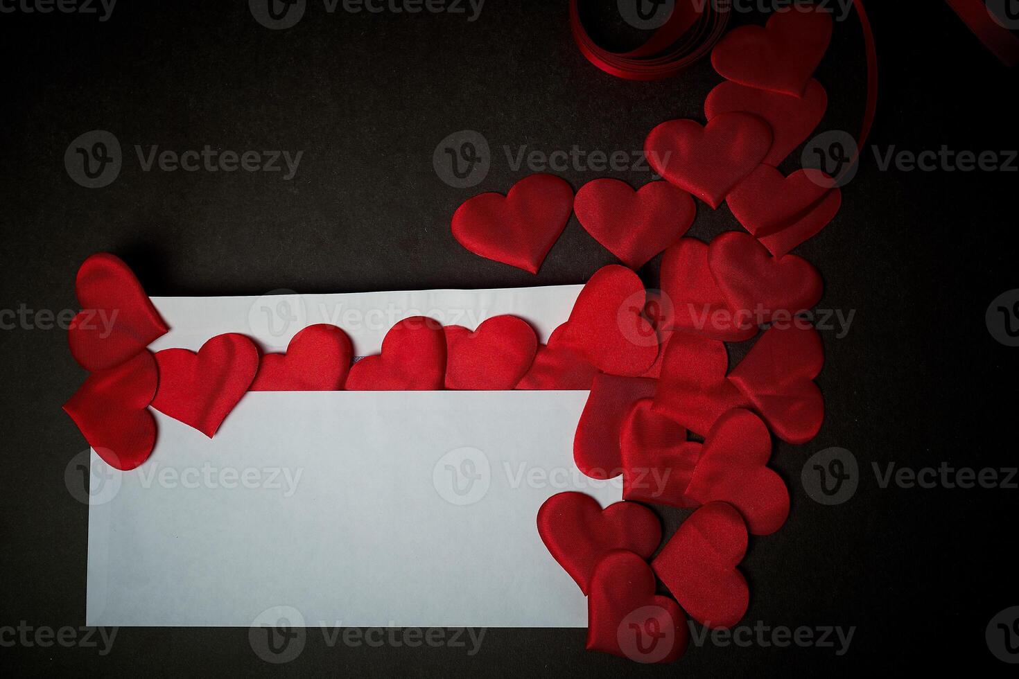 Valentine's day,a Declaration of love. White envelope with red hearts. Valentine. On a dark gray background. photo