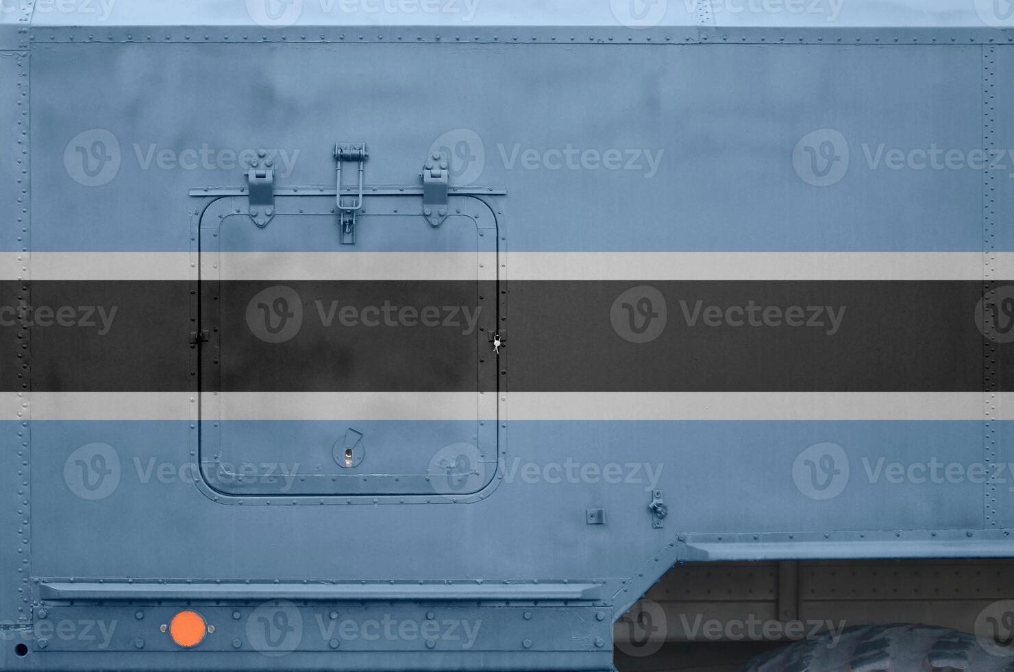 Botswana flag depicted on side part of military armored truck closeup. Army forces conceptual background photo