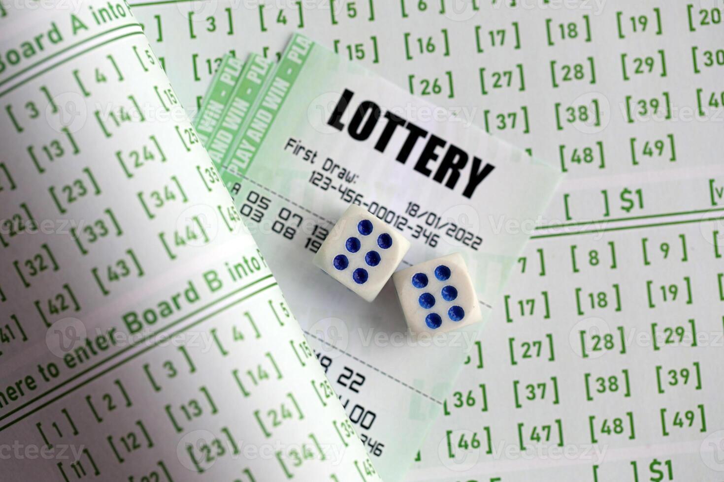 Lottery tickets and dice on blank bills with numbers for playing lottery photo