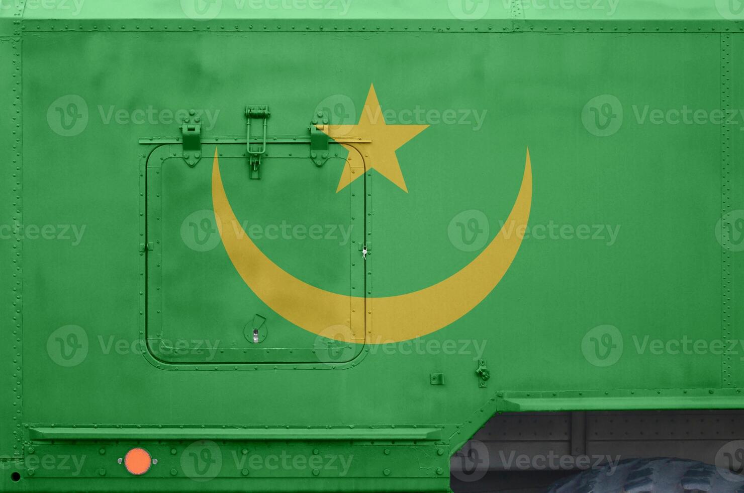 Mauritania flag depicted on side part of military armored truck closeup. Army forces conceptual background photo