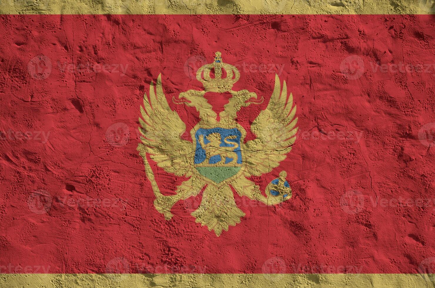 Montenegro flag depicted in bright paint colors on old relief plastering wall. Textured banner on rough background photo